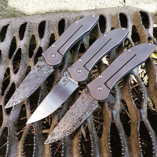 3 non-locking 'pinch-joint' folders in titanium and Damasteel or 154CM