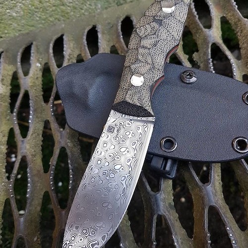 Gorgeous Rose pattern Damasteel skinner with black micarta and red liners.